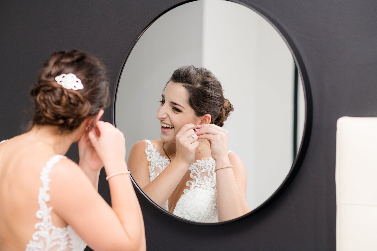 6_Bride-looks-in-mirror-as-she-puts-on-earrings_2047