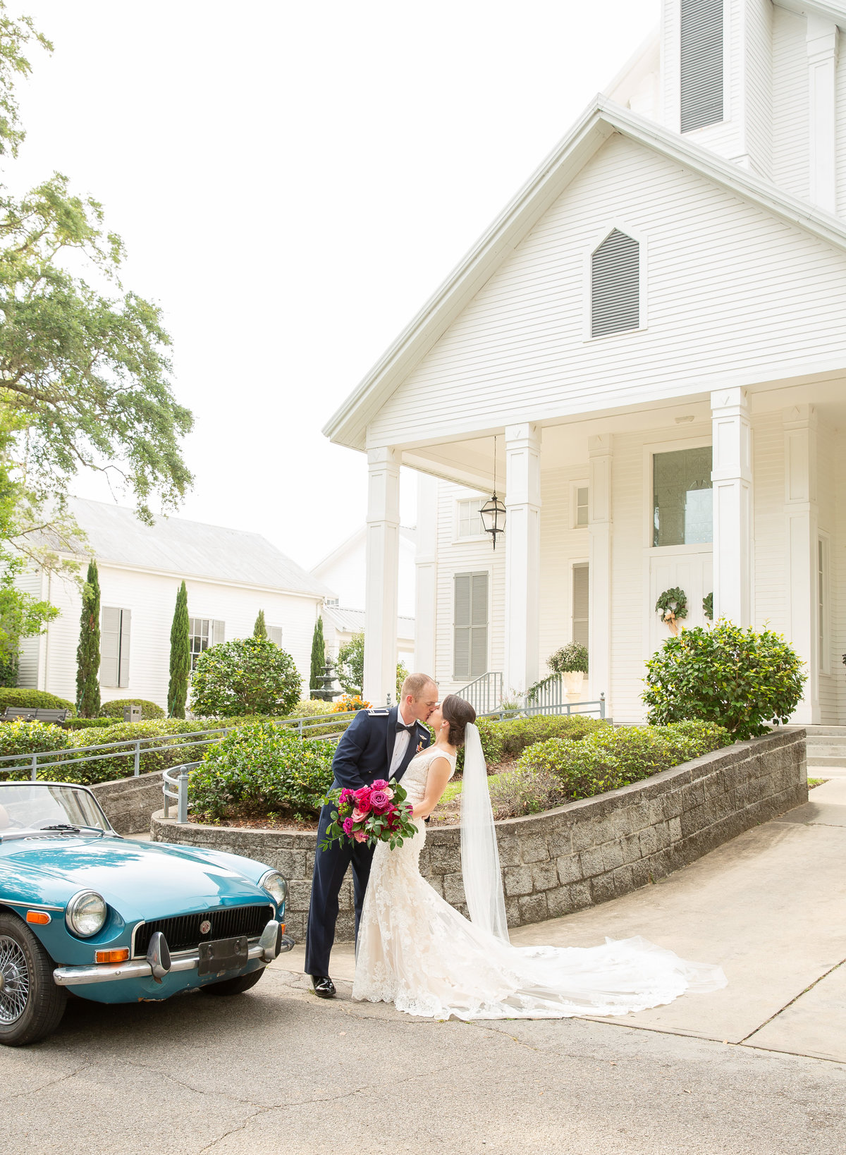 Dip kiss with antique car in front of the First Presbyterian Church in Ocean Springs, Mississippi