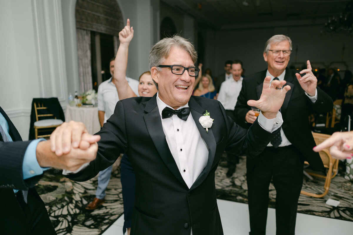 A father dances at his daughters wedding reception.