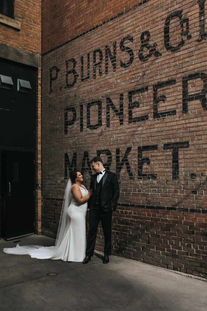 Bride and groom at The Pioneer, a historical industrial wedding venue in Calgary, featured on the Brontë Bride Vendor Guide.
