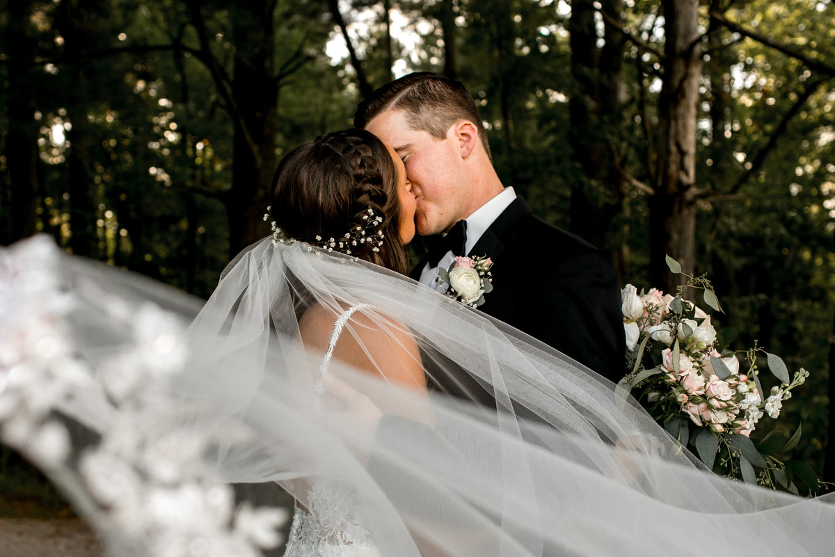 Wedding Couple in Des Moines Iowa with veil shot.