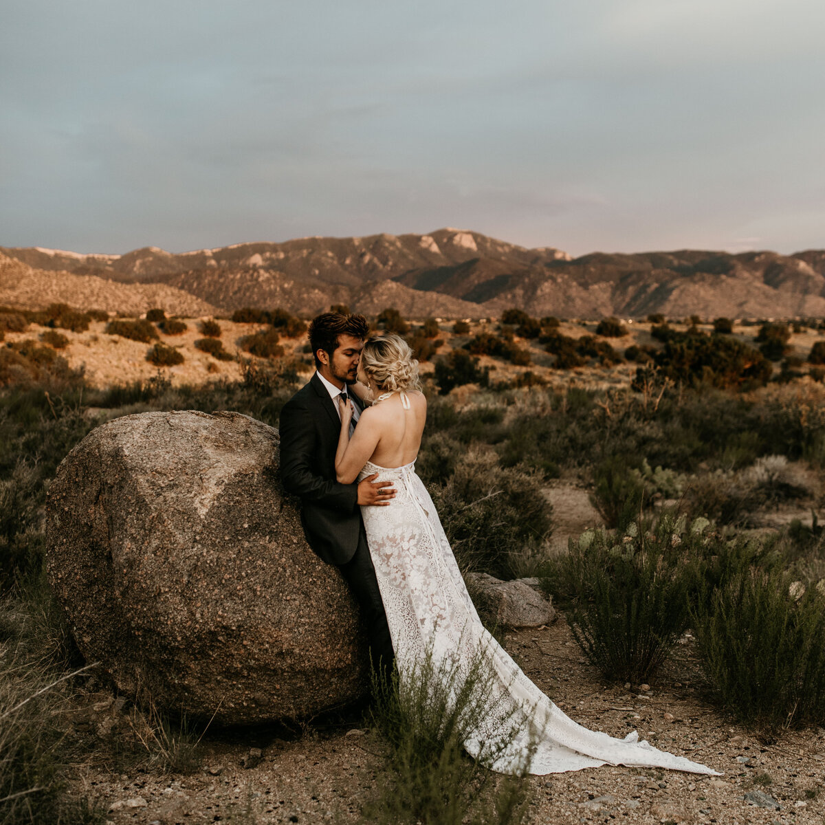 bride and groom holing each other in New Mexico desert