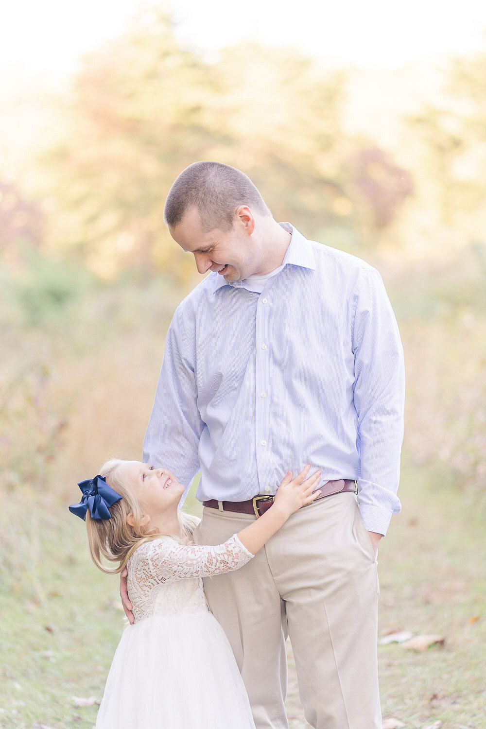 dad and daughter looking at each other during fall mini session taken by a Fairfax, VA photographer