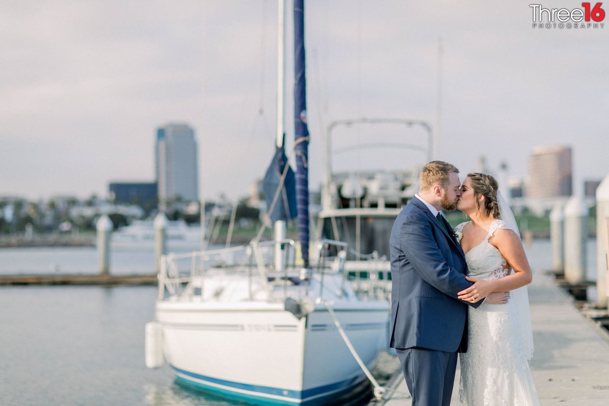 Bride and Groom share a kiss on the harbor dock