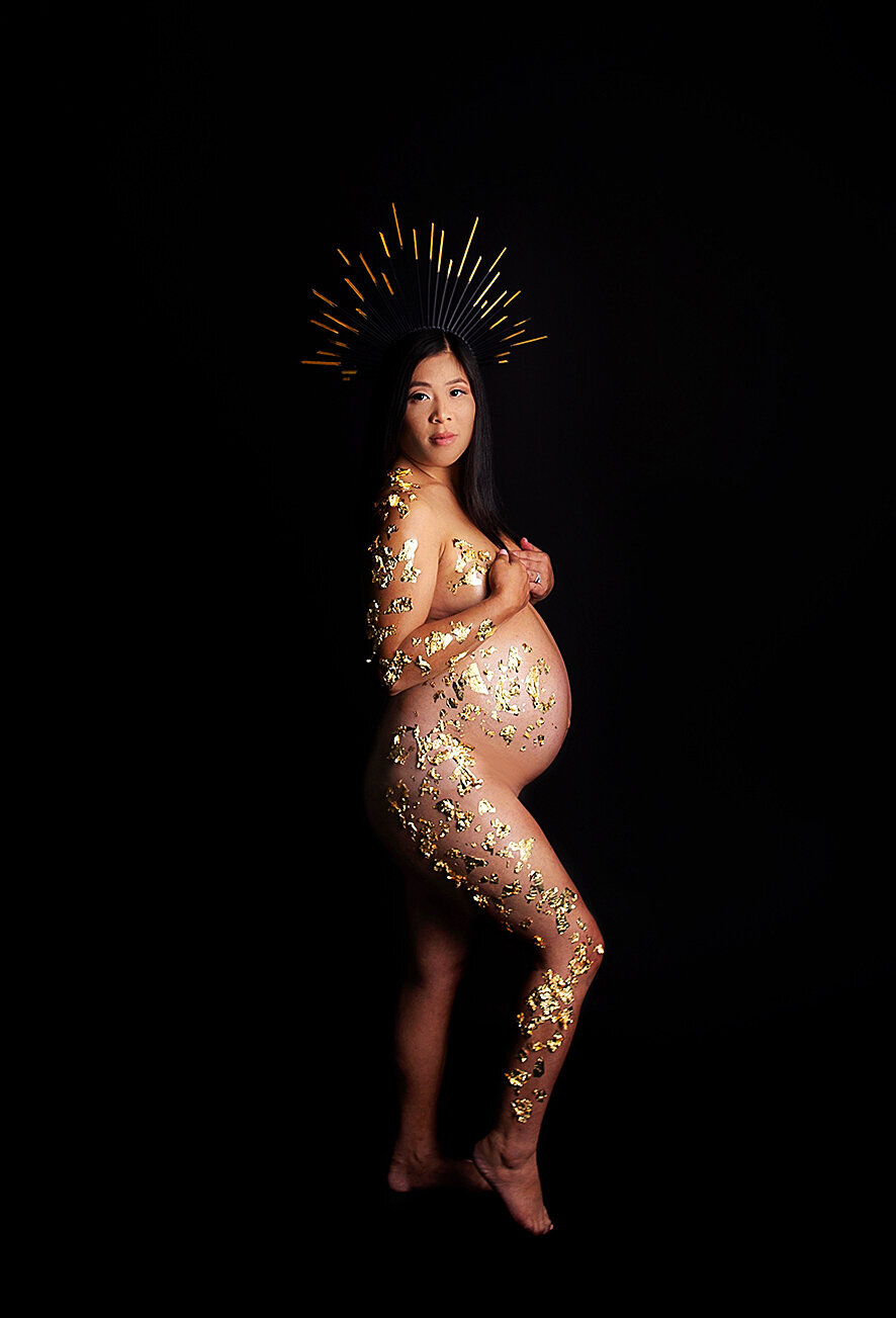 Pregnant mom with gold crown posing during maternity photoshoot in Brentwood tennessee photography studio