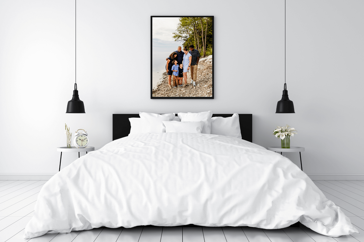 image of a framed family photo hanging above a bed in a modern bedroom in Green Bay
