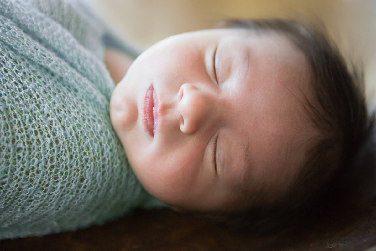 sleeping newborn baby boy wrapped in blue New City baby photographer Milestone Images