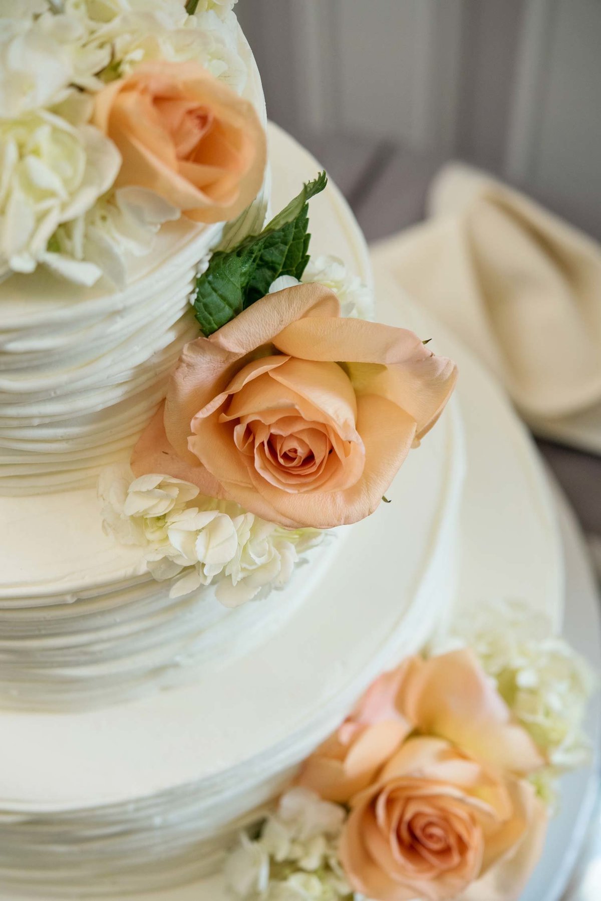 Close up of white wedding cake with flowers at Flowerfield