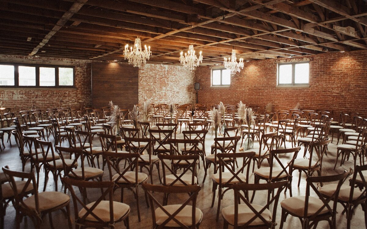 Wedding ceremony with chairs in a circle at indoor Colorado wedding venue in Longmont