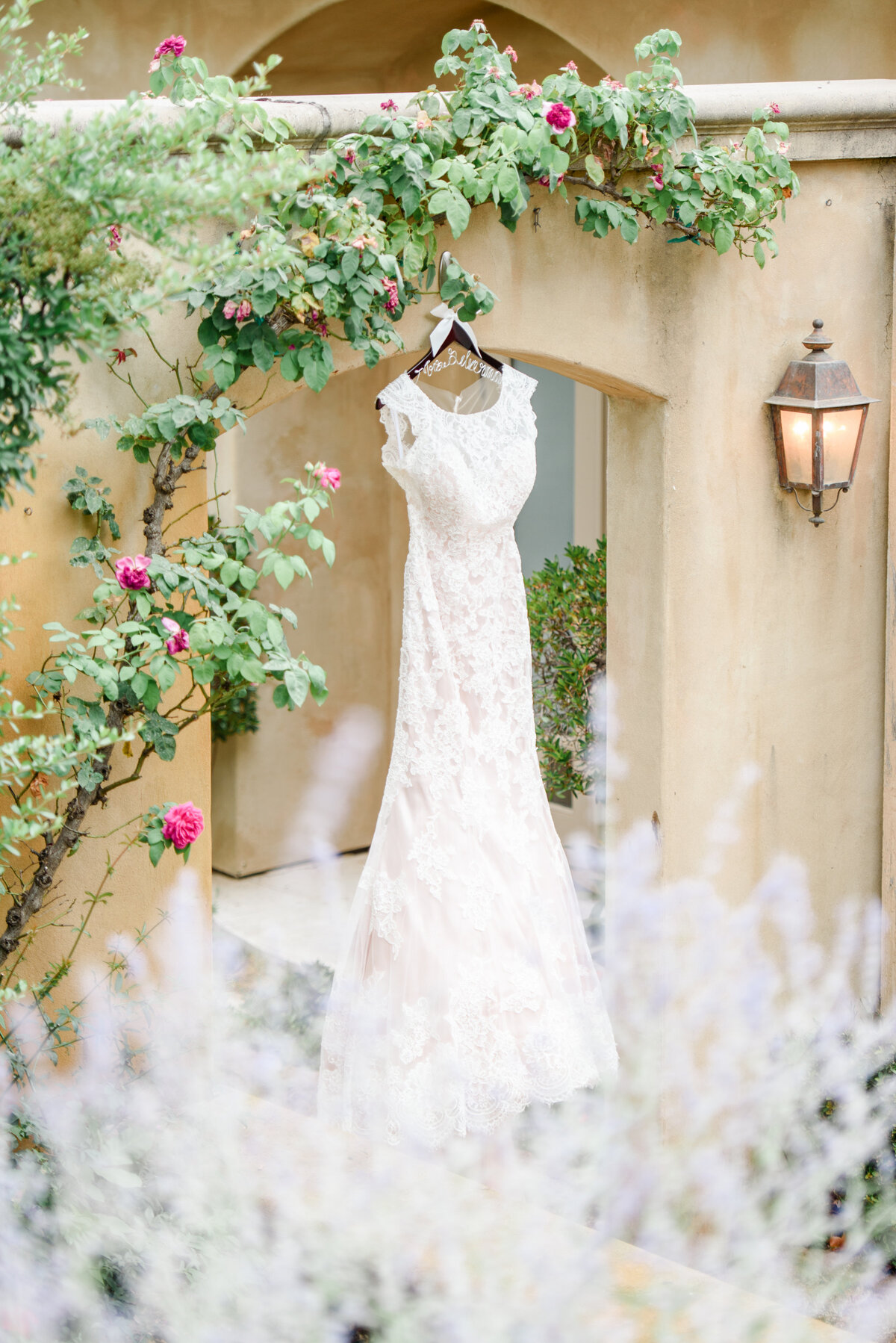 a beautiful white wedding dress hanging