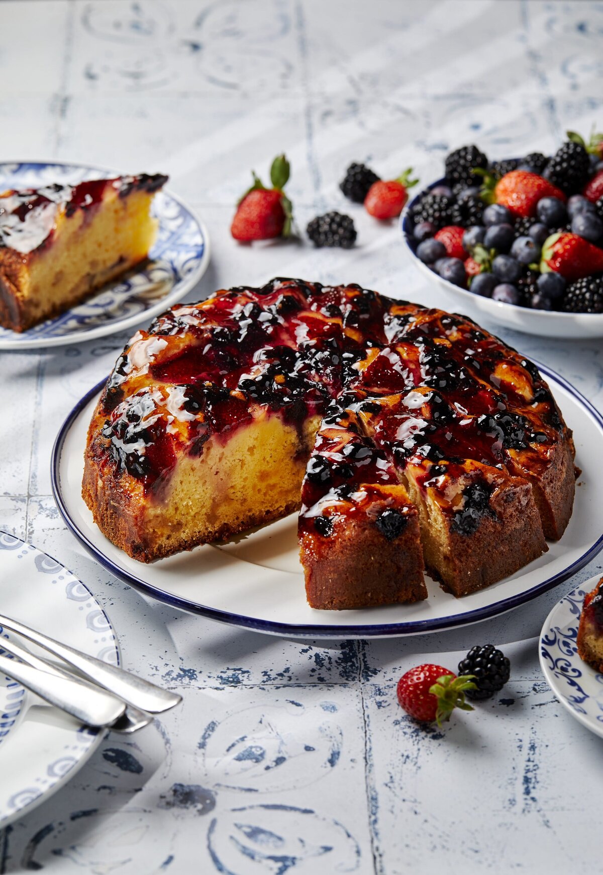 A round cake topped with a berry medley.