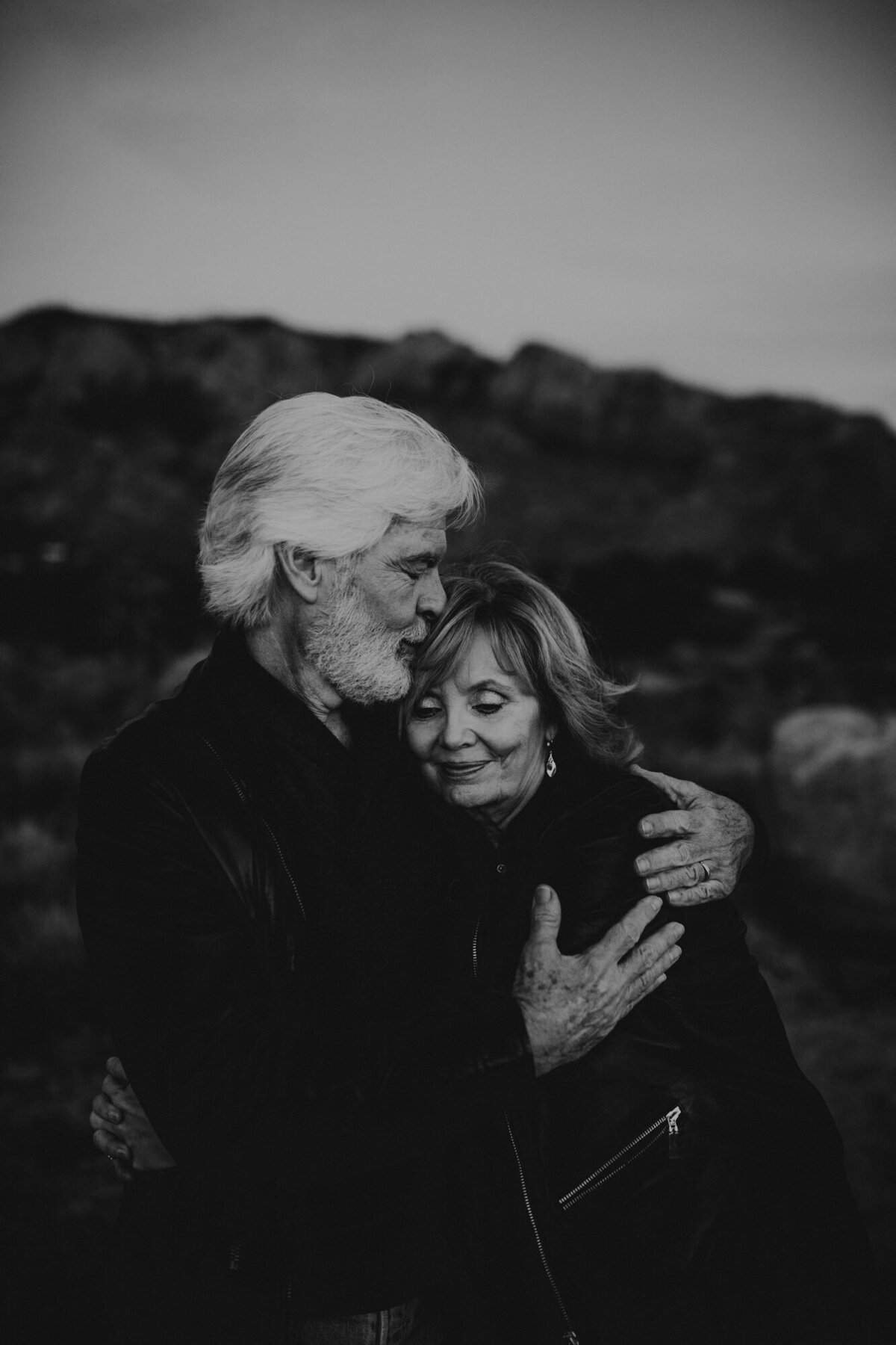 black and white photo of a middle aged couple hugging