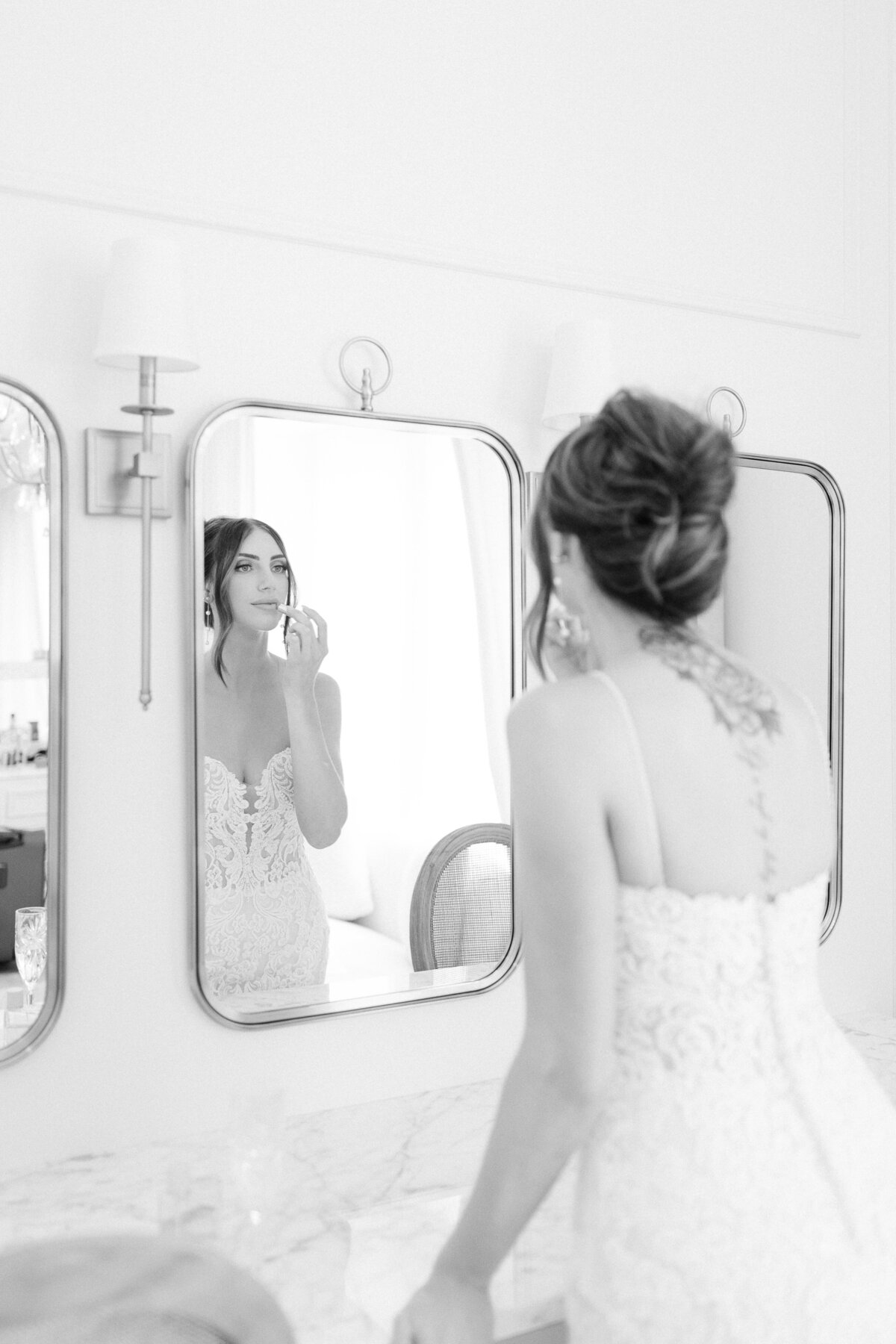 Bride getting ready in the mirror