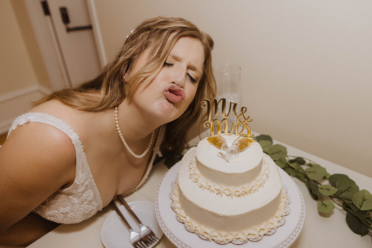 bride posing during cake cutting at denver colorado wedding