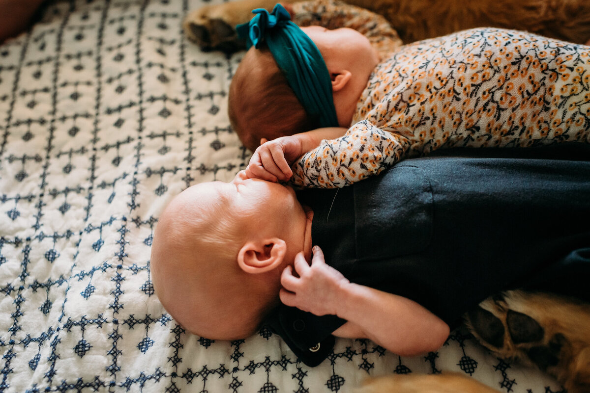 Newborn Photographer, Twin brother and sister babies holding hands.