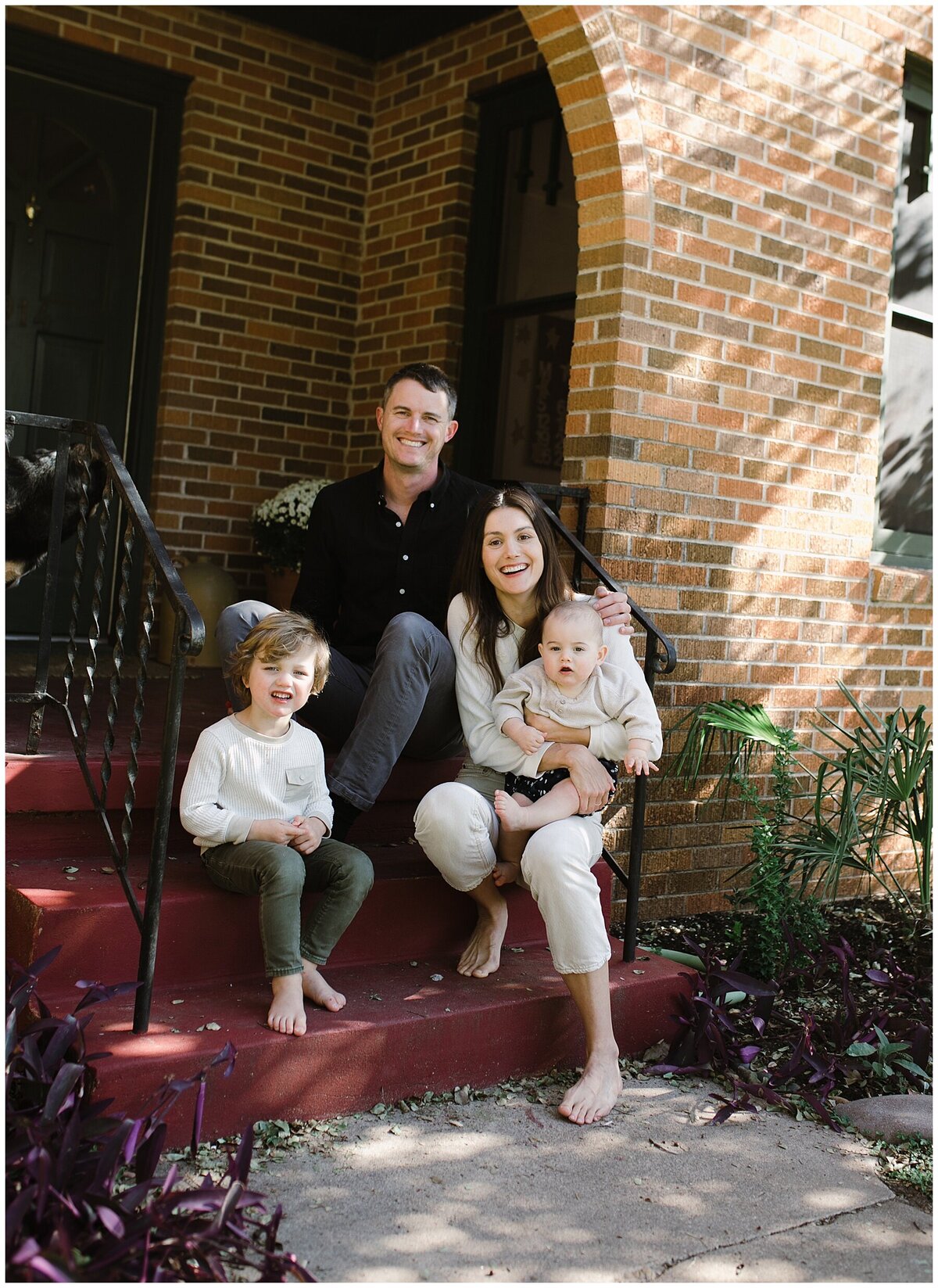 Family sitting on front steps of home with toddler and baby at sweet home family session in Austin by Amber Vickey Photography