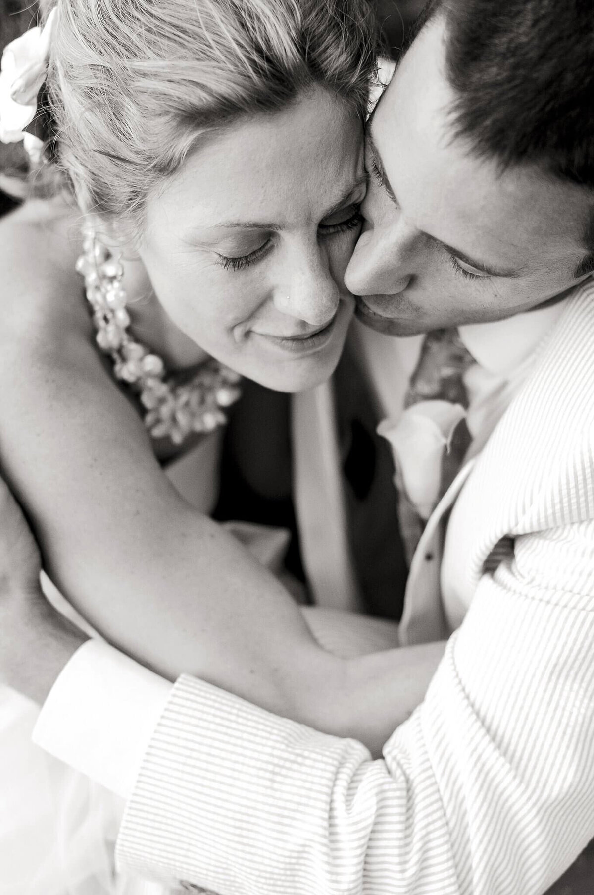bride and groom embrace close up