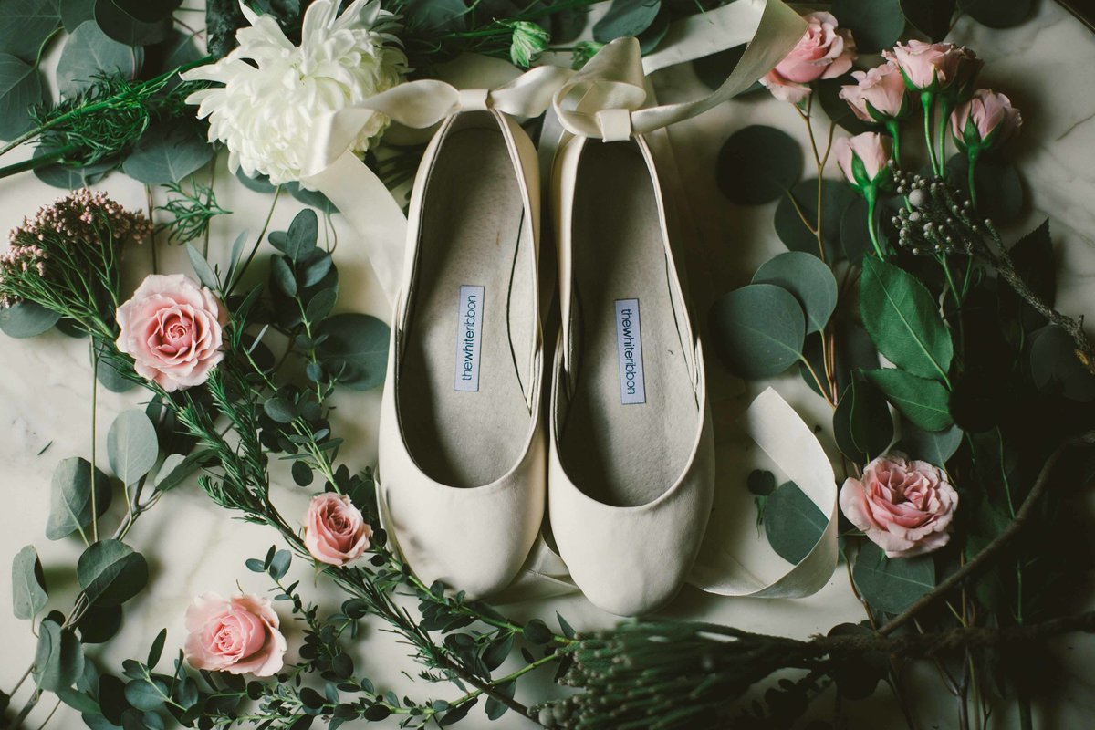 Shoes sit on roses at Inn at Irwin Gardens wedding