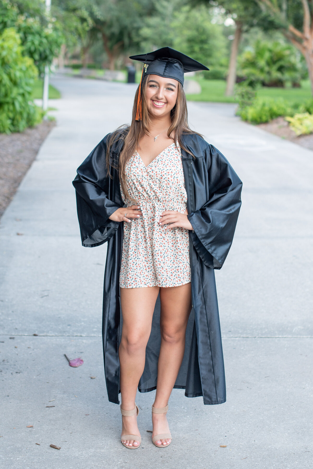 High school senior girl in cap and gown by Orlando Senior Photographer Khim Higgins.