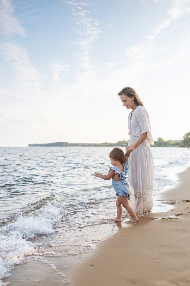 Family session of little girl and her mother at the beach