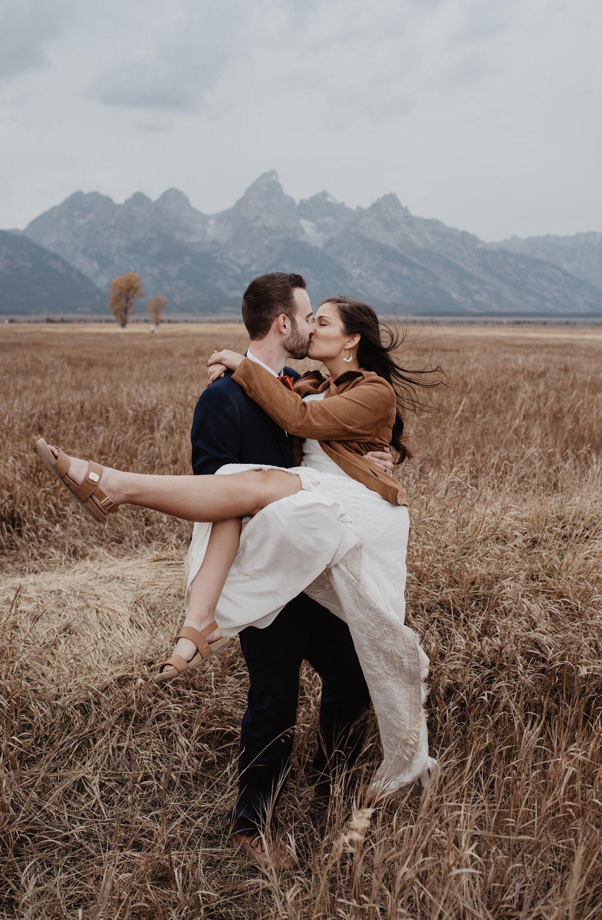 Photographers Jackson Hole capture groom lifting bride