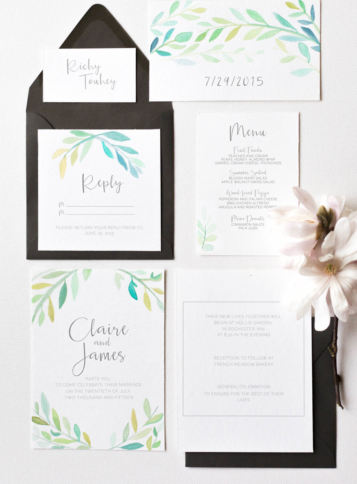 simple wedding invite suite styling of watercolor and foliage black accents and magnolia flowers