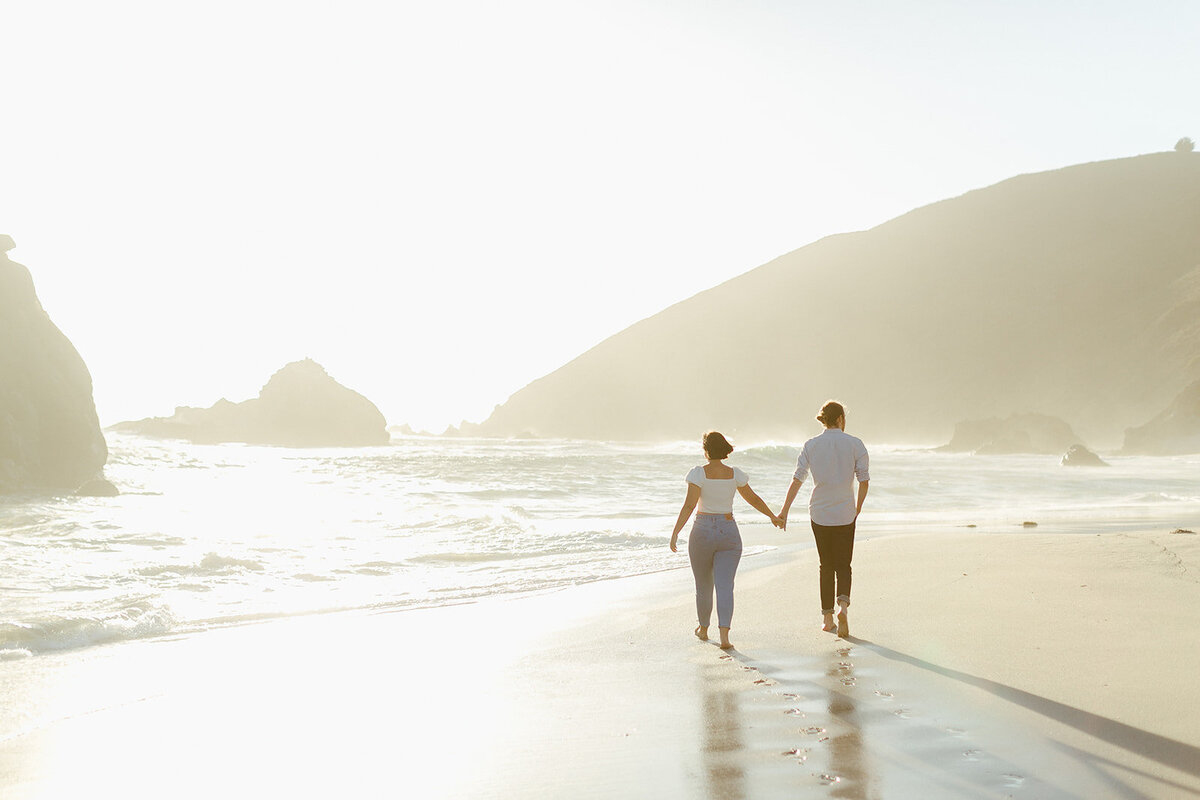 Couple walks into the sunset at Pfeiffer Beach, Big Sur, California. Photo by Jordan Katz.