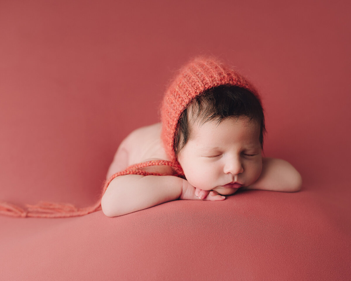 Newborn photos in Medford Oregon with hands on chin, By Katie Anne