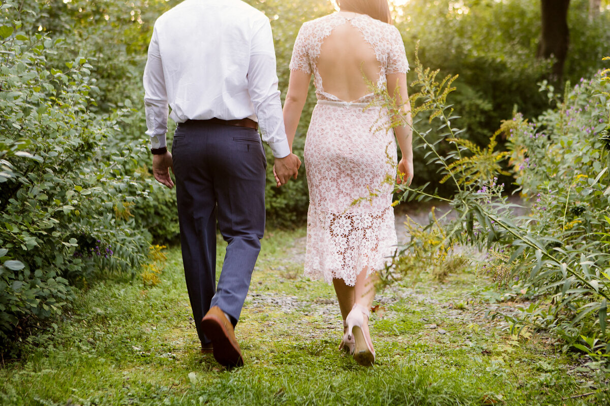 Couple holding hands walking through nature in Buffalo, New York