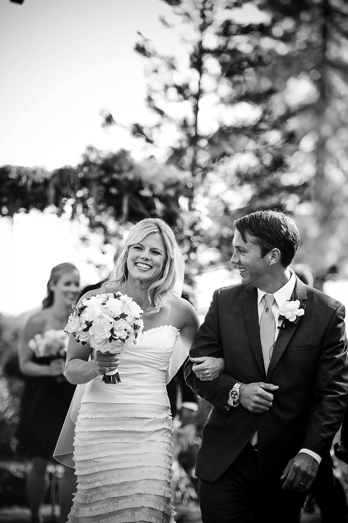 Just married feels of bride and groom walking down the aisle happy. Black and white image at Hyatt Tahoe