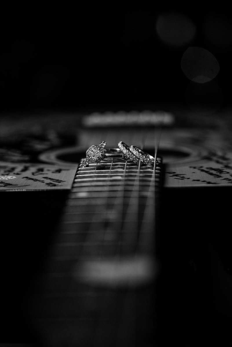 creative photo of wedding rings on a guitar