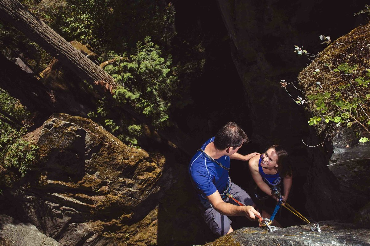 couple rock climbing during engagement session