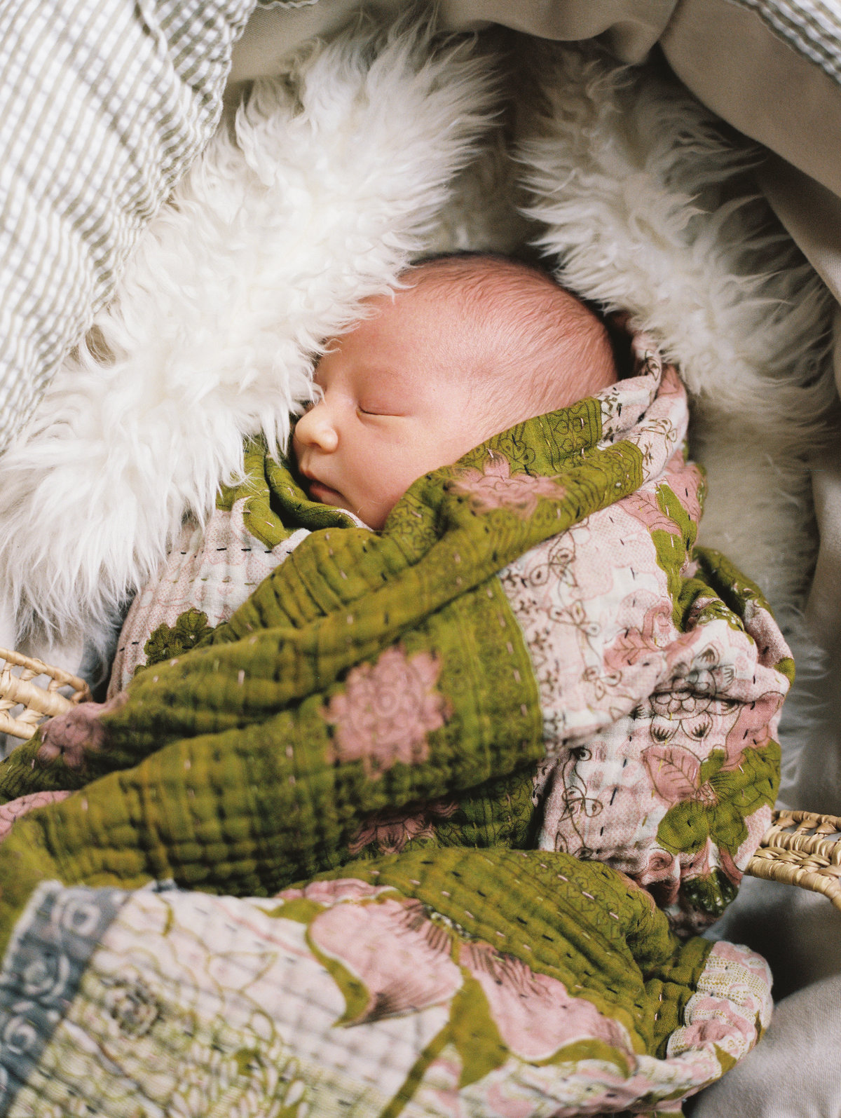 newborn baby wrapped in blankets sleeping
