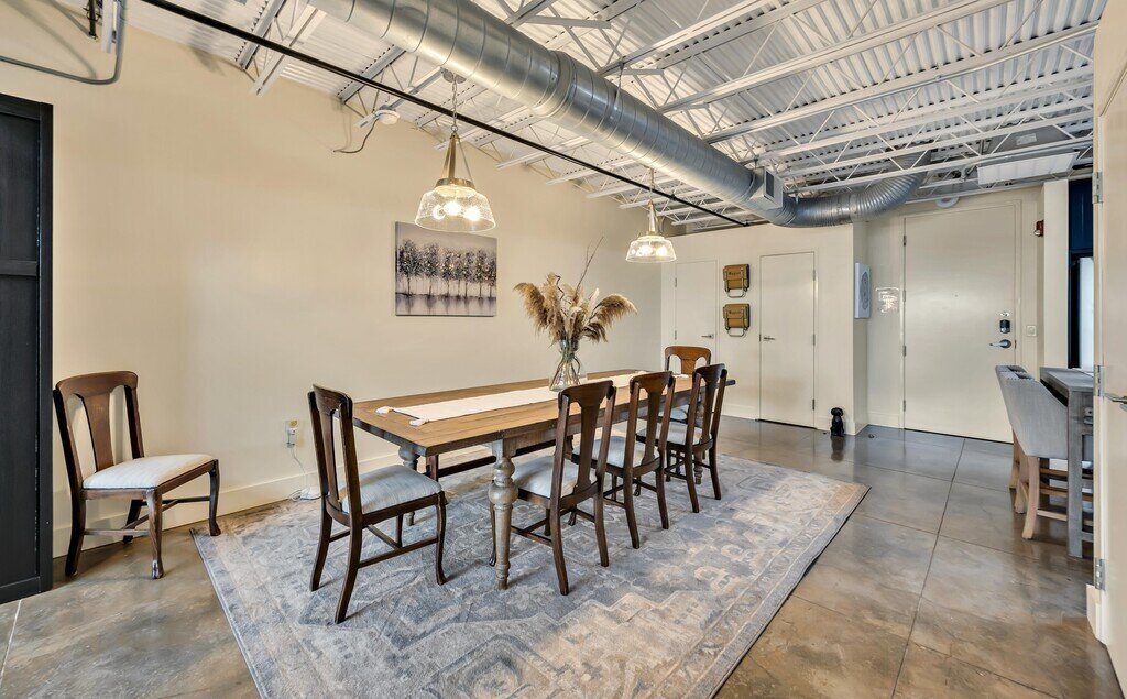 Beautiful dining area for eight in this 2 bedroom, 2.5 bathroom luxury vacation rental loft condo for 8 guests with incredible downtown views, free parking, free wifi and professional decor in downtown Waco, TX.