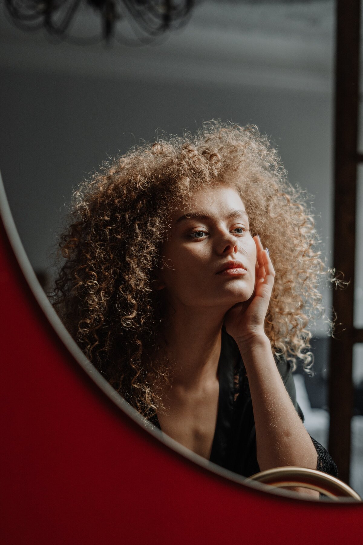 woman-in-black-shirt-holding-her-face-4154177