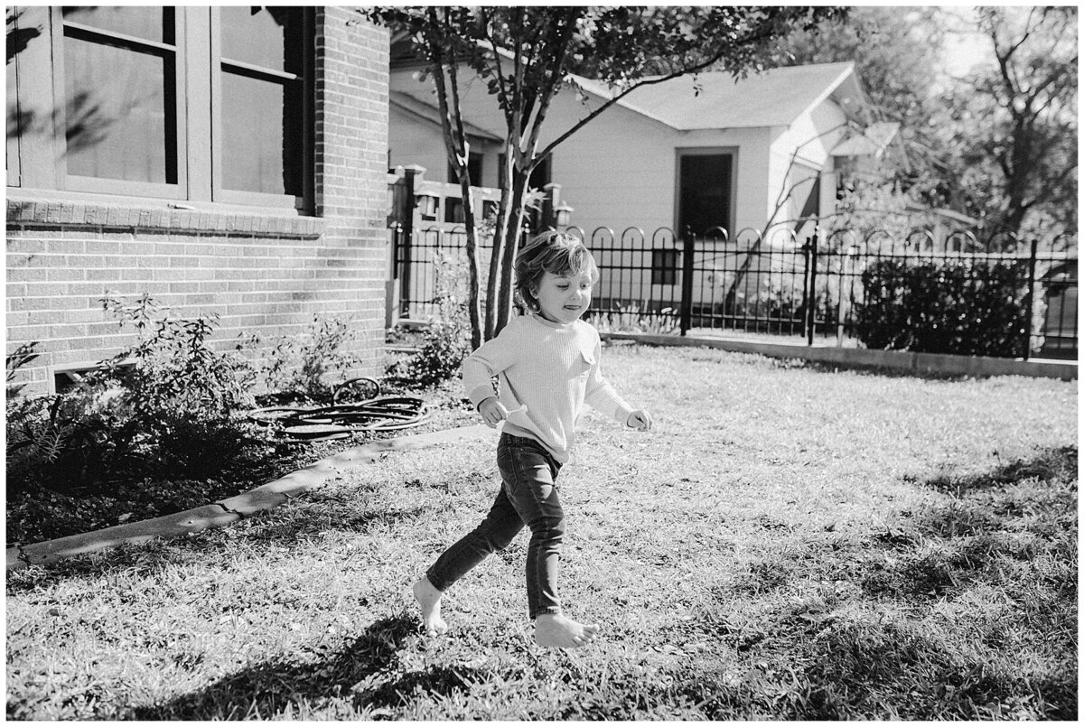 Baby playing in back yard of Austin home at sweet home family session in Austin by Amber Vickey Photography