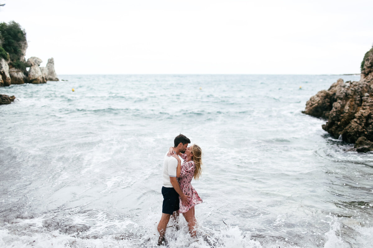 couple-embrace-standing-in-sea-at-engagement-shoot-in-cap-dantibes