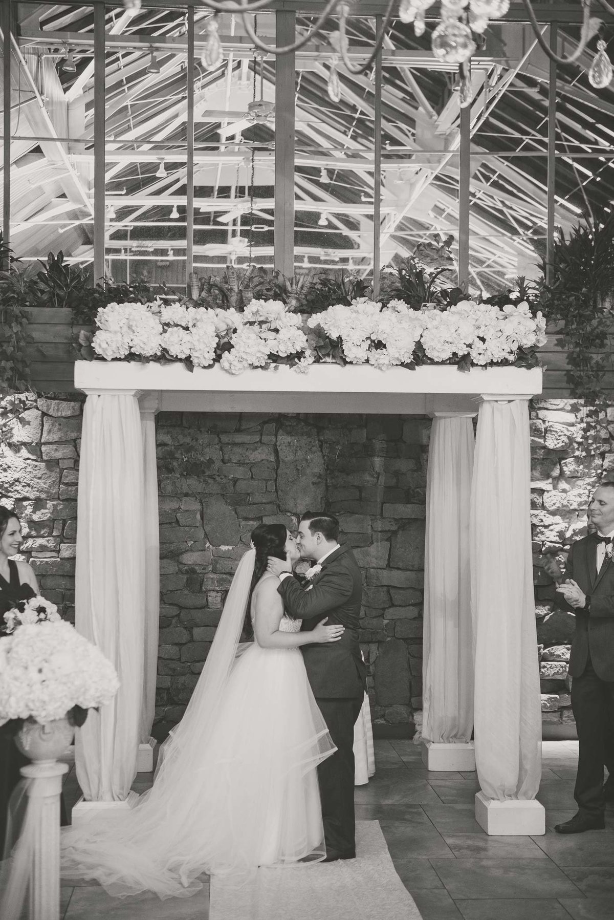 Fox Hollow wedding ceremony photo, bride and groom kissing.