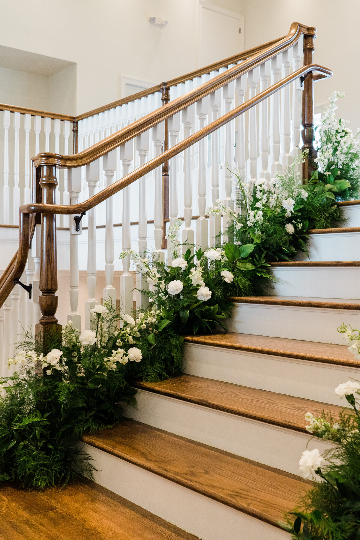 romantic curved staircase surrounded by flowers