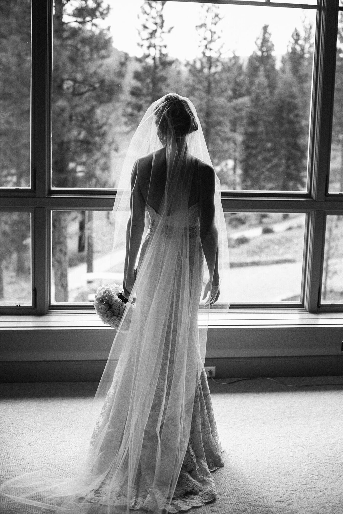 bride looking out window at wedding in martis camp