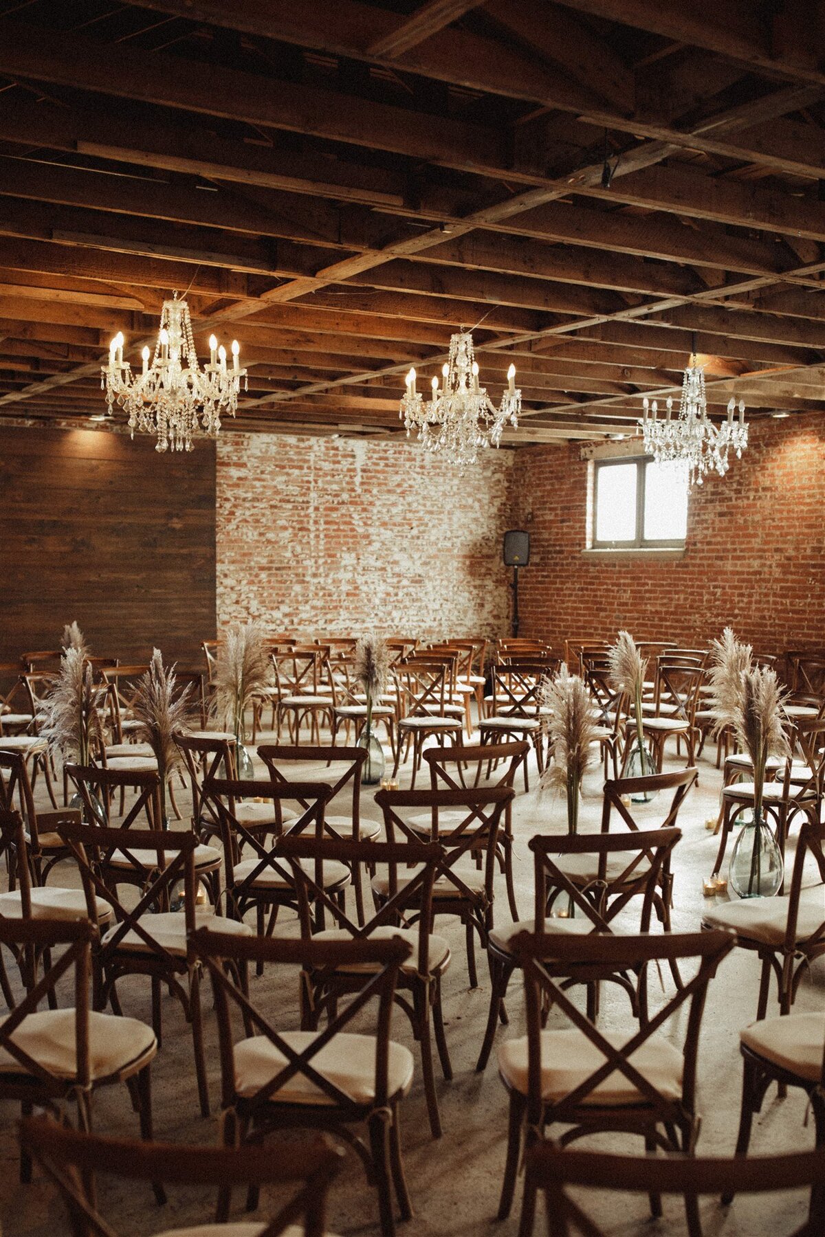 wedding ceremony with pampas grass and chandeliers at Longmont wedding venue, The St Vrain