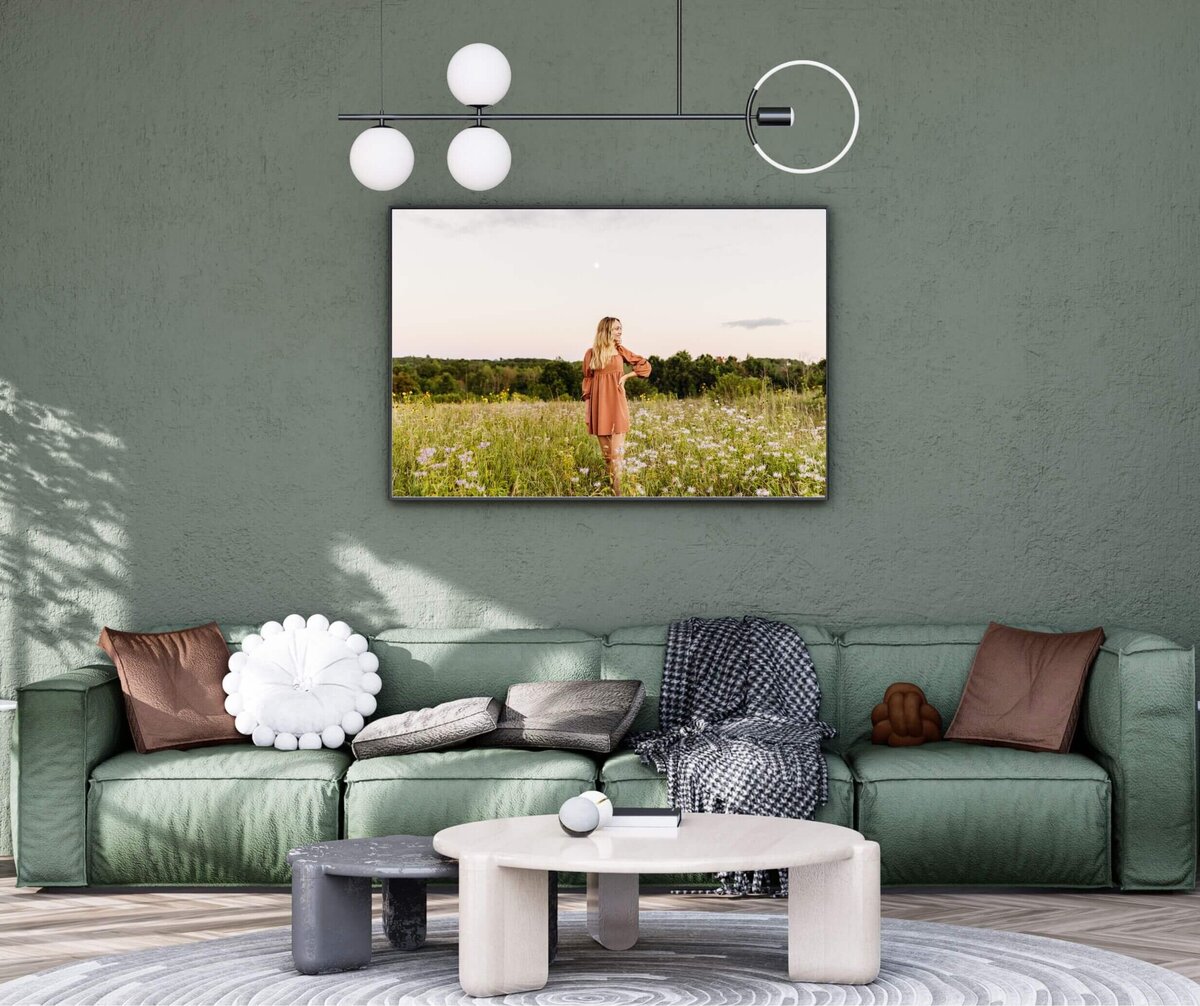 portrait of a senior girl standing in a flower field hanging in a modern green living room