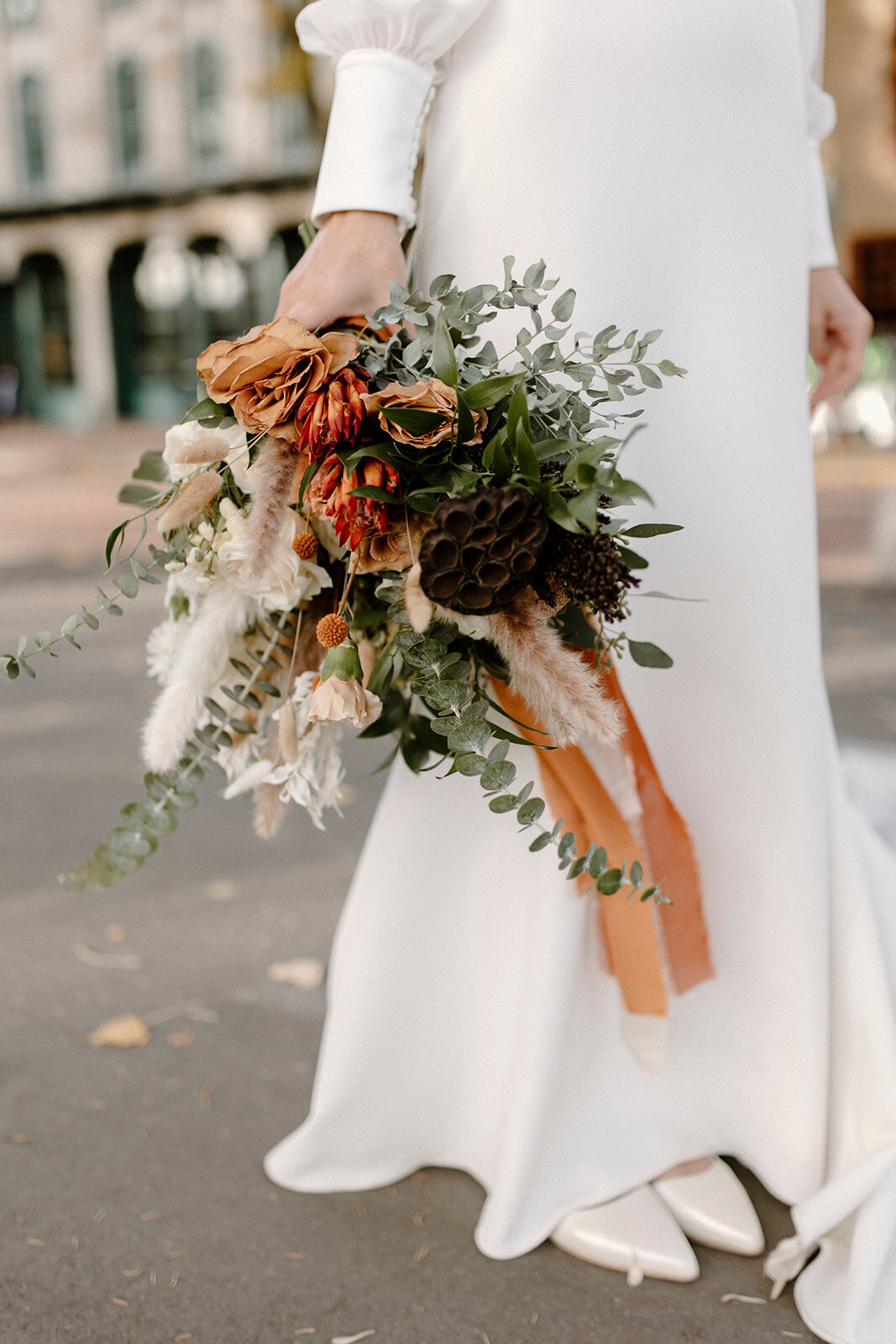 bride holding a flower bouquet with autumn colors