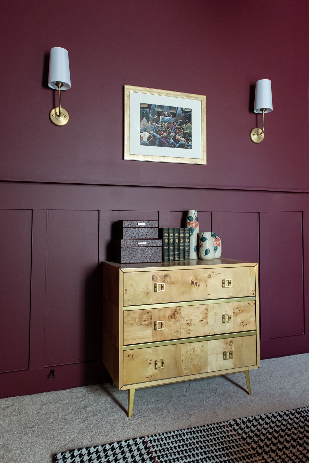 a gold dresser in a room with maroon walls