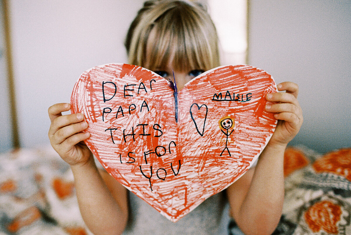 colorado girl holds a heart card to camera