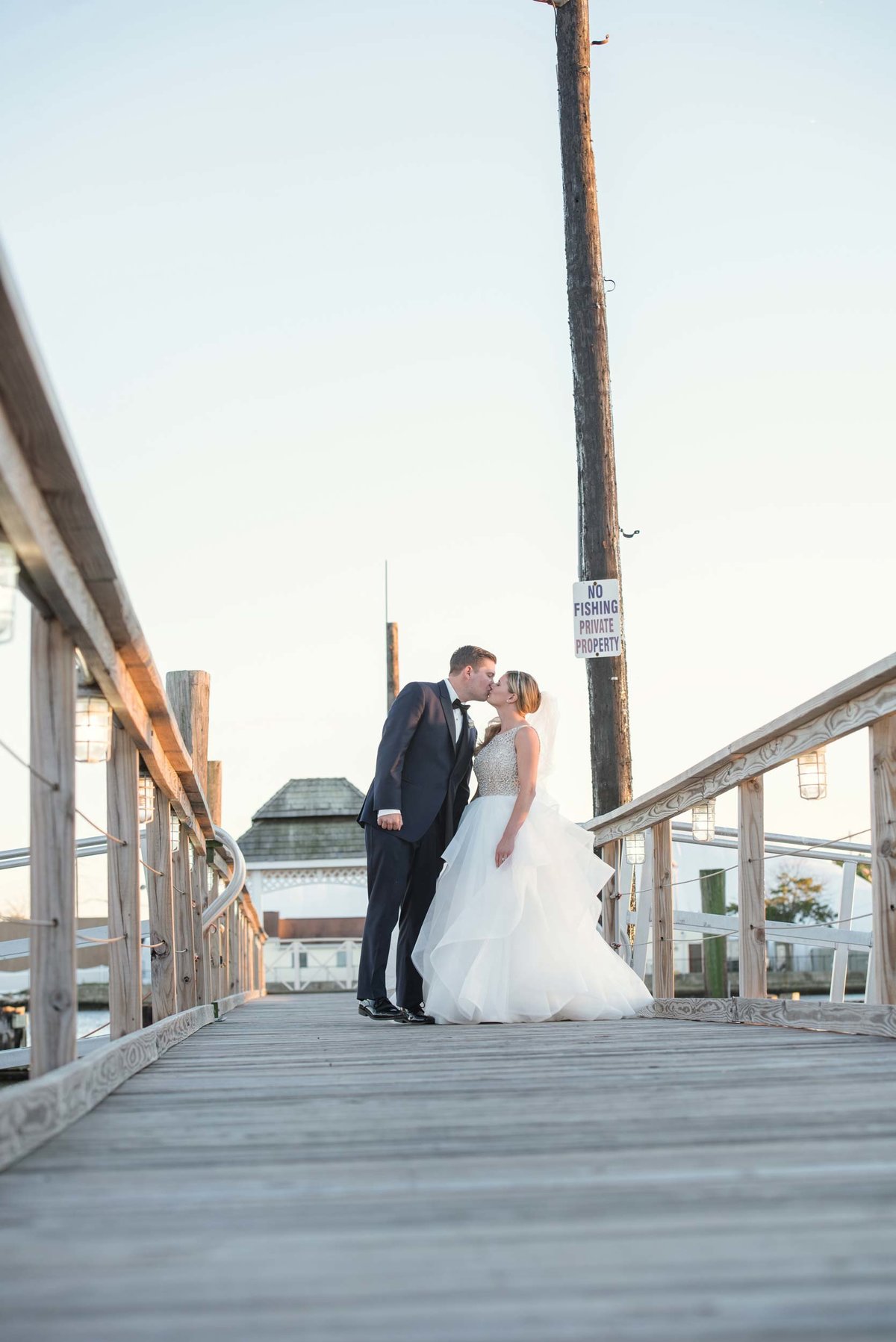 Bride and groom kissing at the docks of Bridgeview Yacht Club