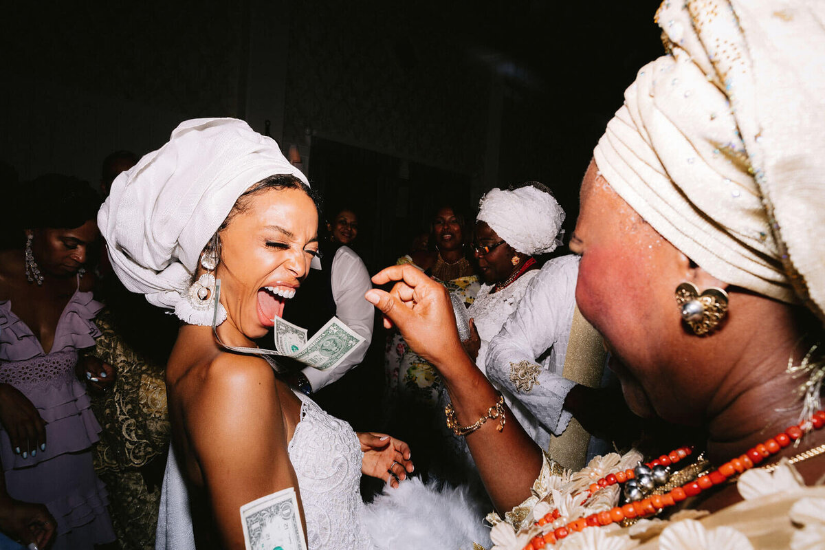 The bride is happily doing money dance in Montage at Palmetto Bluff. Destination Wedding Image by Jenny Fu Studio