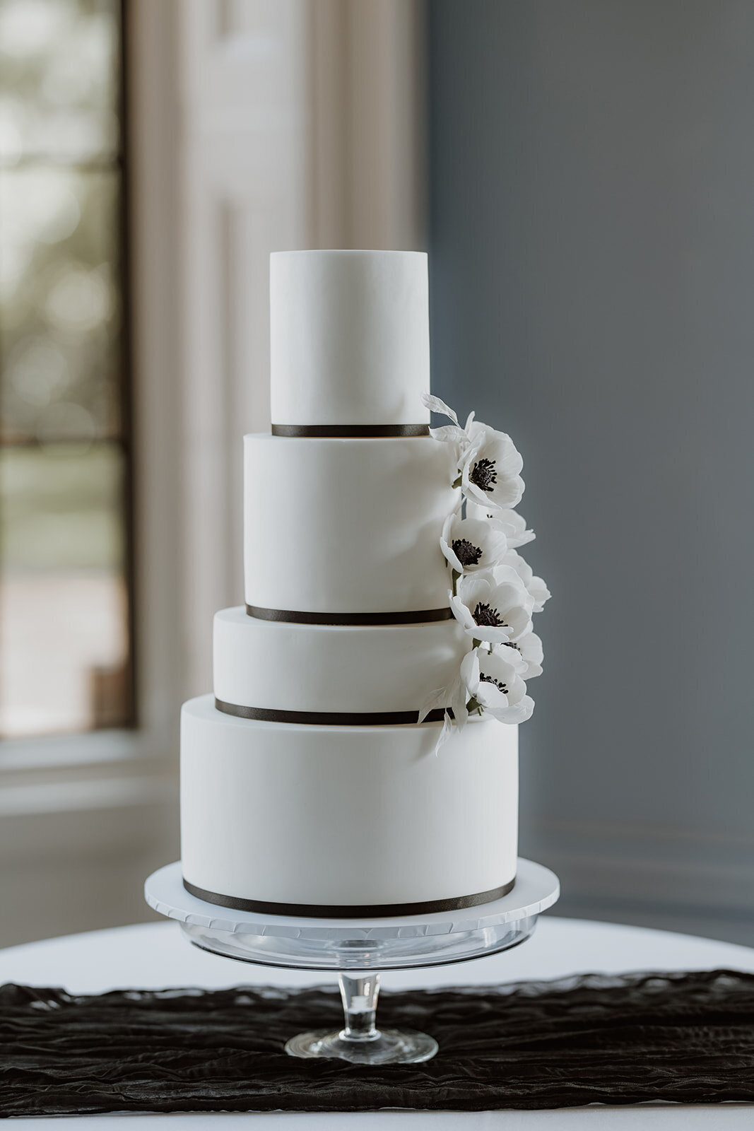 Elegant black and white wedding cake with sugar anemones