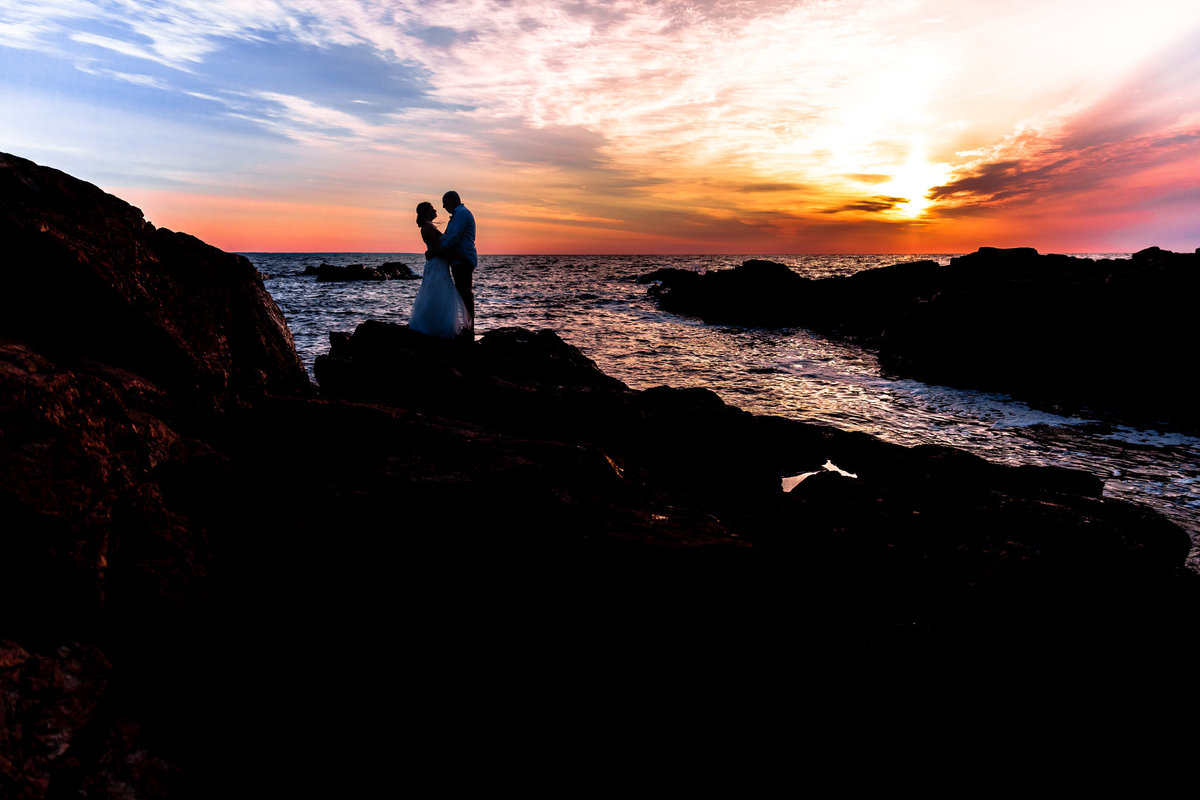 Ogunquit Maine Elopement with the couple standing in front of the sunrise on the day of their wedding