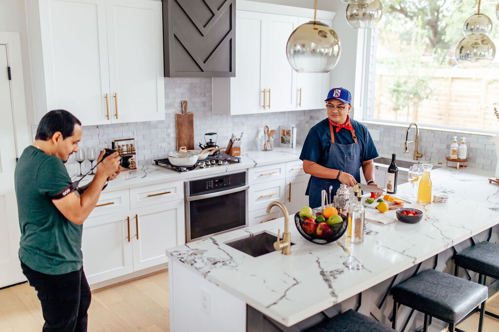 Chef taking photos in modern kitchen at 201 Lofthaus in Houston, TX